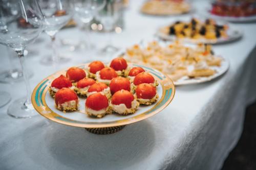 a plate of food with strawberries on a table at CHATEAU DE BRINVILLE in Saint-Sauveur-sur-École
