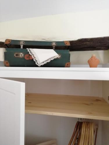 a suitcase sitting on top of a shelf at CASA LUCERTOLA in Apricale
