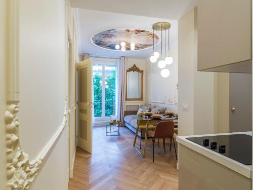a kitchen and a dining room with a table in a room at The Gatsby Suite in Paris