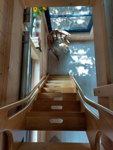 a winding staircase in a building with a window at Węgiełek Treehouse in Kazimierz Dolny
