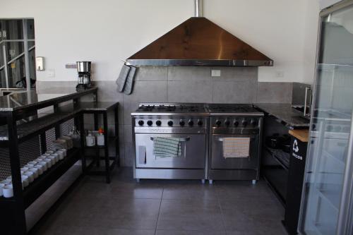 a kitchen with a stainless steel stove and a counter at Dormís Acá in Esquel