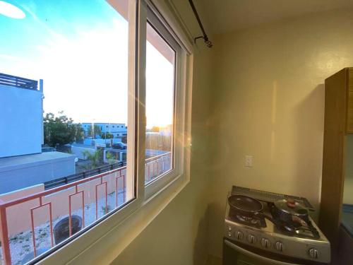 a kitchen with a stove and a large window at Spacious Apartment Minutes from the Beach in Jan Thiel