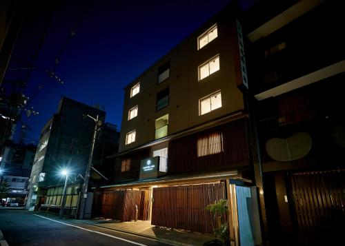 a building on a street at night at Tassel Inn Kyoto Kawaramachi Nijo in Kyoto