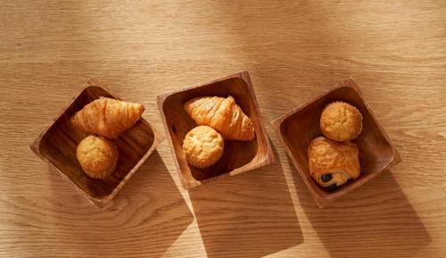 threeartments of food sitting on top of a wooden table at Tassel Inn Kyoto Kawaramachi Nijo in Kyoto