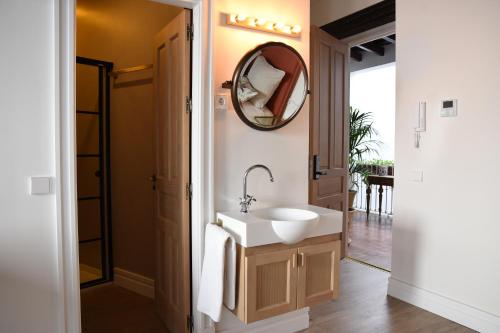 a bathroom with a sink and a mirror at Casa Bailen Sevilla in Seville