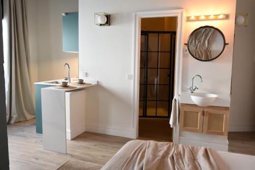 a bathroom with two sinks and a mirror at Casa Bailen Sevilla in Seville