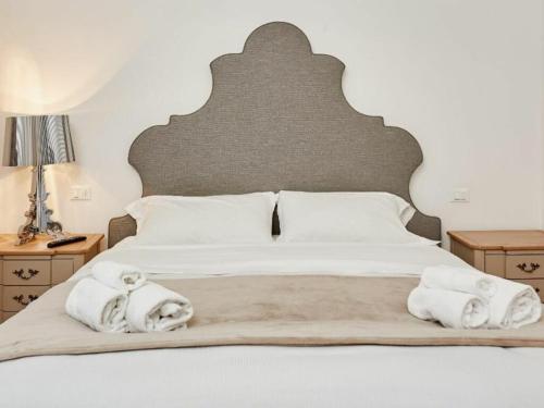 a bedroom with a large bed with towels on it at Vallazze Luxury in Milan
