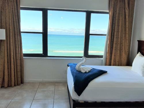 a bedroom with a swan on a bed with a large window at Ocean Front Units at Miami Beach in Miami Beach