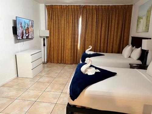two swans on two beds in a hotel room at Ocean Front Units at Miami Beach in Miami Beach