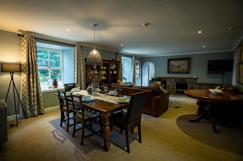 een woonkamer met een tafel en een bank bij The Farmhouse, 6 bed property, Forres in Forres