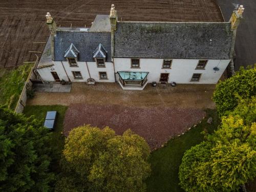 an aerial view of a large house with a window at The Farmhouse, 6 bed property, Forres in Forres