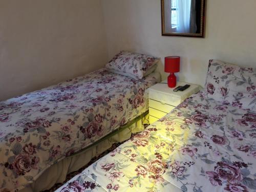 two beds sitting next to each other in a room at Heila's in house Family room-Homestay! in Bloemfontein