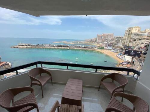 a balcony with chairs and a view of a beach at شقةفاخرةبجليم على البحر مباشرة in Alexandria