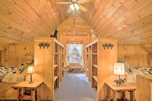 a bedroom in a log cabin with two beds at Rustic Rothbury Cabin with Resort Amenity Access! in Rothbury