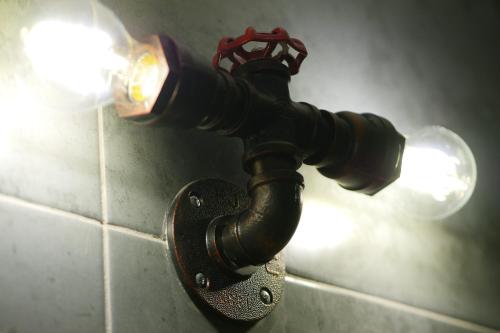 a black pipe attached to a wall with a light at Greta, apartament cèntric i amb encant in Tremp