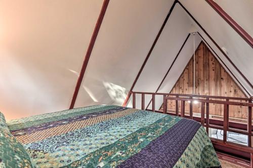 a bed in a room with an attic at Cozy Toledo Bend A-Frame with Waterfront Views! in Burkeville