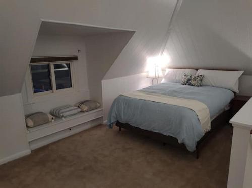 a bedroom with a bed and a window at Rancher's Capitol Lodge in Cheyenne
