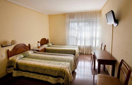 Un pat sau paturi într-o cameră la Hostal Hispano