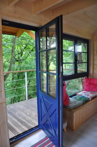 a door of a tiny house with a porch at Węgiełek Treehouse in Kazimierz Dolny