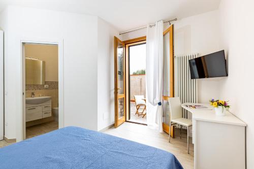 a bedroom with a bed and a desk and a bathroom at Agriturismo Il Bosco in Terricciola