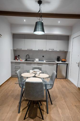 a kitchen with a table and chairs in a room at Meteora vibes in Kalabaka