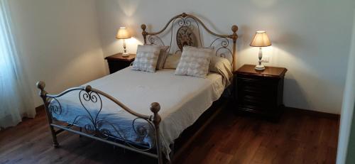 a bedroom with a bed with two night stands and two lamps at Casa Al Lago in Bolsena