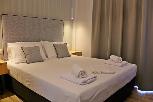 a hotel room with a bed with towels on it at Oneiro Zois in Prinos