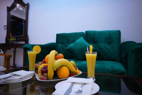 a tray of fruit on a table in a living room at Petra Elite Hotel in Wadi Musa