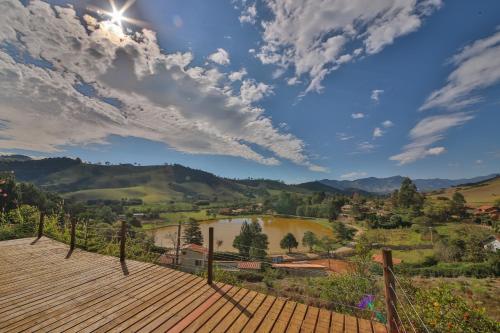 a view from the deck of a house with a lake at Casa Estrelada in São Bento do Sapucaí