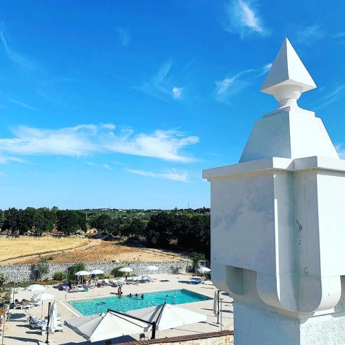 a resort with a swimming pool and a building at Masseria Del Crocifisso in Polignano a Mare