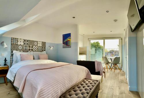 a bedroom with a large bed and a window at LUX Studio Loft in London