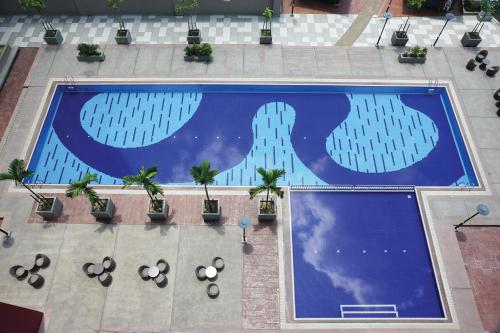 an overhead view of a large swimming pool with buildings at UTM Hotel & Residence in Kuala Lumpur