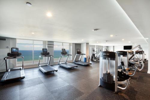 a gym with cardio machines and a view of the ocean at Daytona Grande Oceanfront Resort in Daytona Beach