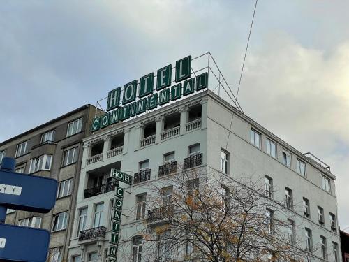 a building with a sign on the top of it at Hotel Continental Gare du Midi in Brussels