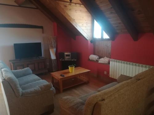 a living room with two couches and a tv at Pirinargi Apartamento in Abaurrea Alta