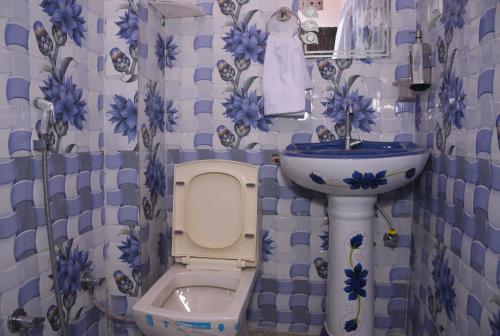 a bathroom with a toilet and a sink at Laxmi Residence in Jaipur