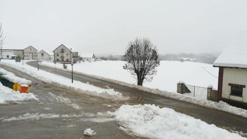 a snow covered street with snow on the ground at Pirinargi Apartamento in Abaurrea Alta