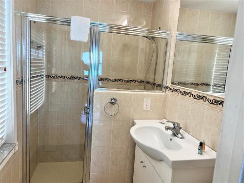a bathroom with a sink and a shower at Ocean Front Units at Miami Beach in Miami Beach