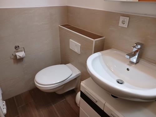 a bathroom with a white toilet and a sink at Stubnerblick in Bad Gastein