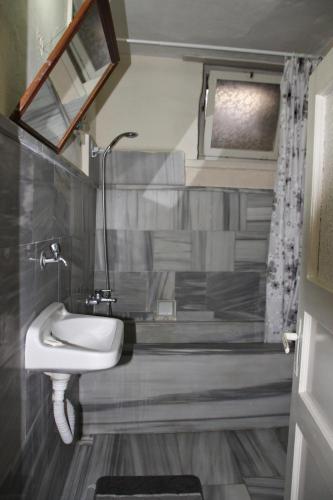 a bathroom with a sink and a mirror at Odyssey Guest House in Bergama