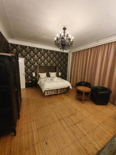 a bedroom with a bed and a chandelier at Brussels 1904 in Brussels