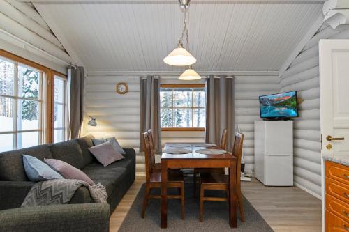 a living room with a couch and a table at Hallan Akka Apartments in Hyrynsalmi