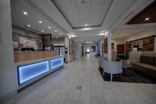 a lobby of a hospital with tables and chairs at Holiday Inn Express Hotel & Suites Oklahoma City-West Yukon by IHG in Yukon