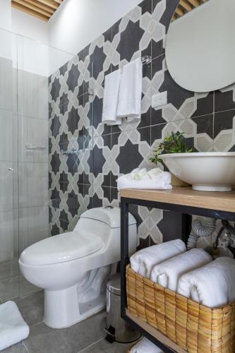 a bathroom with a toilet and a sink at Lexum by Bernalo Hotels in Medellín
