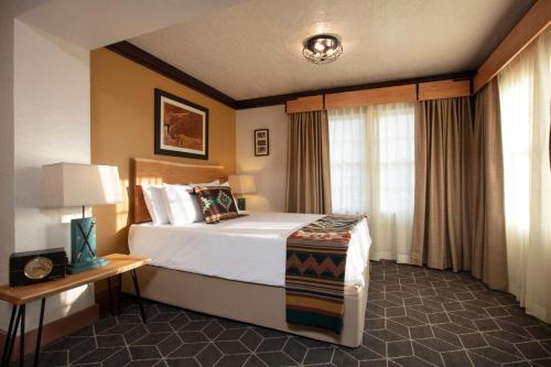 a hotel room with a bed and a window at Hotel El Rancho in Gallup