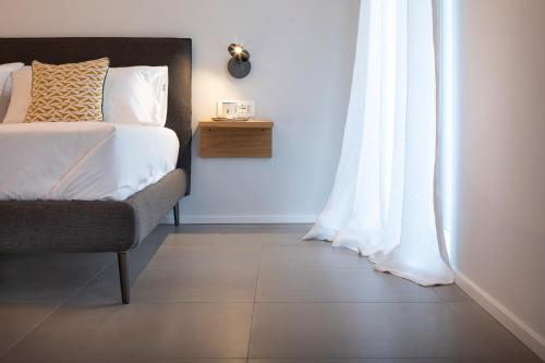 a bedroom with a bed and a white curtain at Camere d'Aria in Locana