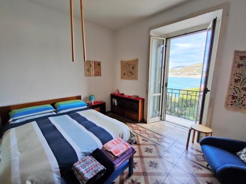 a bedroom with a bed and a view of the ocean at Panoramic Apartment in Villa on The Beach, In Center in Agropoli