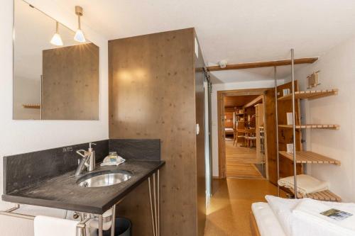 a bathroom with a sink and a mirror at Gasthaus Rössli in Mogelsberg