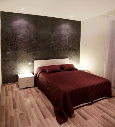a bedroom with a bed and a large painting on the wall at Guest House Roma in Rome