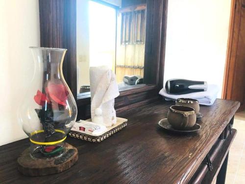 a wooden table with a vase on top of it at Hacienda Valentina in Playa del Carmen